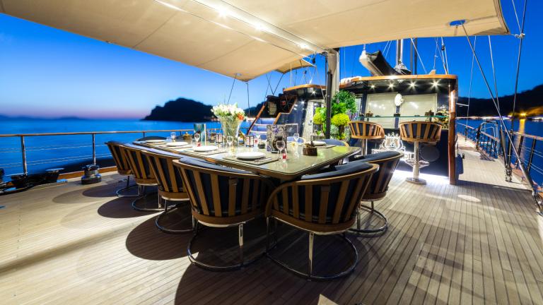 Served table on the Emanuel gulet. Twilight, light is on