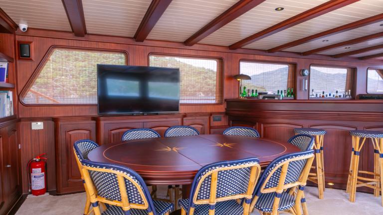 S/Y Voyage Gulet lounge with large table and TV