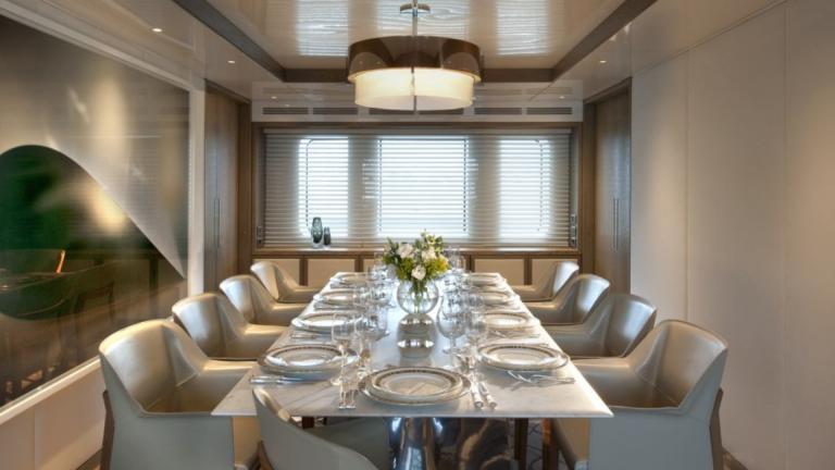 Set table in the interior dining area of this luxury yacht
