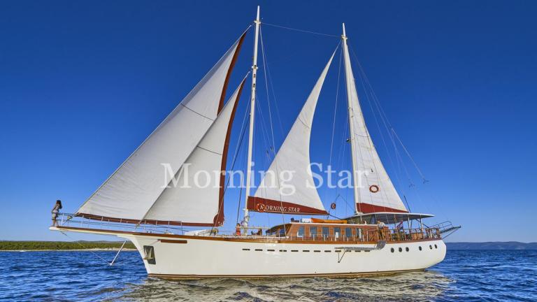 The motor sailor Morning Star with full sails on open sea. Perfect for luxurious sailing adventures.