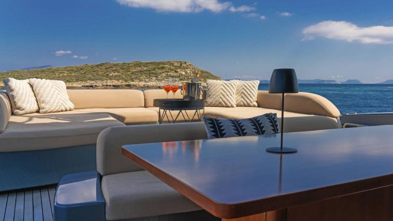 Motoryacht Whatever's aft deck dining table and seating areas
