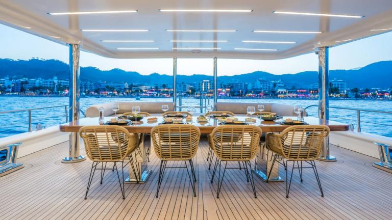 Aft deck dining table of luxury motor yacht Deep Water