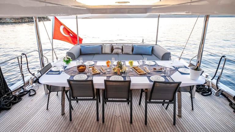 Dining and seating area on the aft deck of luxury yacht Mask 5