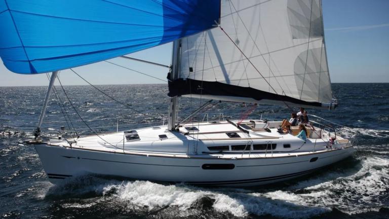 Capella 2 sailing yacht swiftly moves through open sea with wind-filled sails.