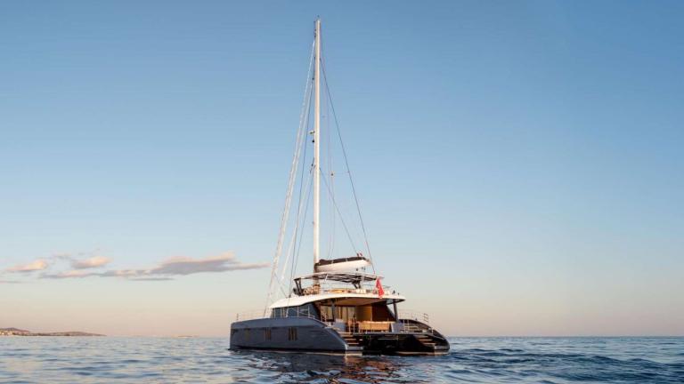 The Adara Next catamaran from Athens glides toward the golden horizon.