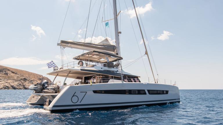 Luxury catamaran Aether (Fountaine Pajot) on blue waters off the coast of Greece.