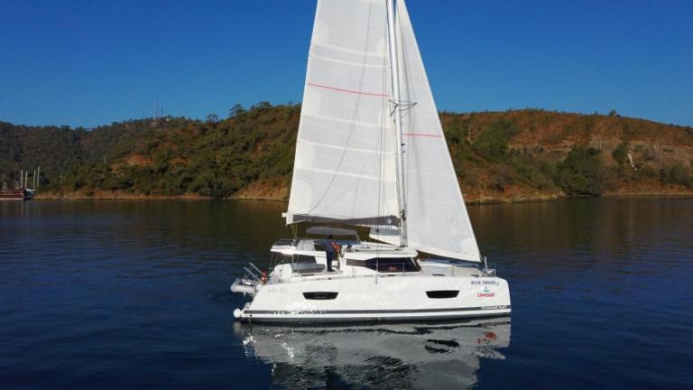 Blue Orion catamaran sailing on calm waters.