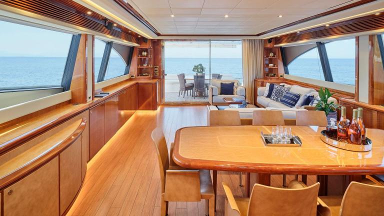Elegant dining and seating area in a yacht with large windows and sea view