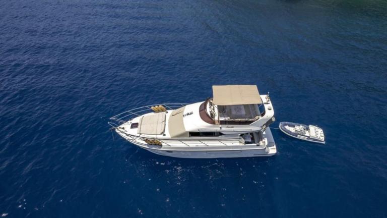 Motor yacht Pina D in the open sea. You can see the boat from behind