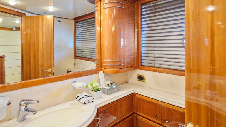 Elegant bathroom on a yacht with wood paneling, mirrors, and modern amenities