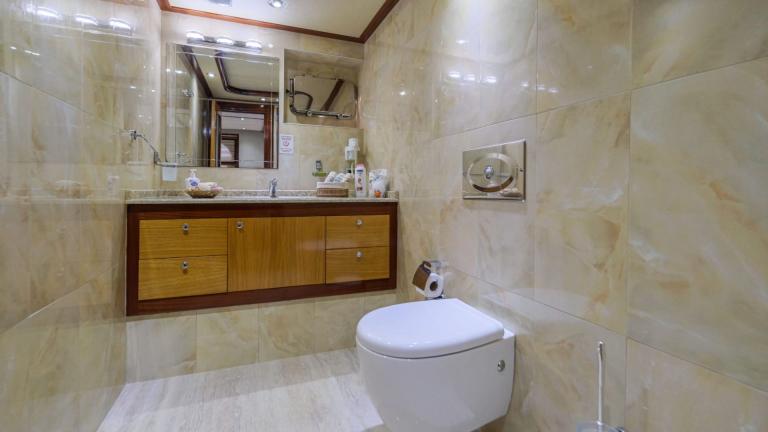 Elegant bathroom with modern fixtures and a large mirror wall.