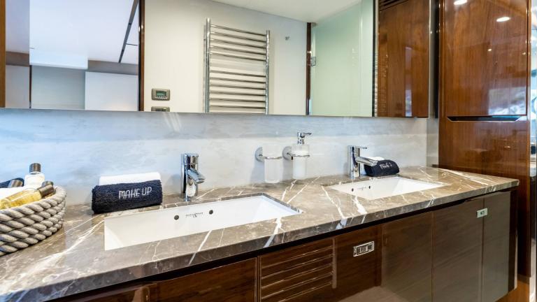 Modern bathroom with double sinks and luxurious amenities.