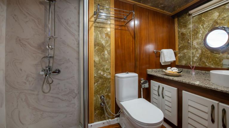 Elegant bathroom with marble decor on the Grand Acar Gulet in Fethiye.