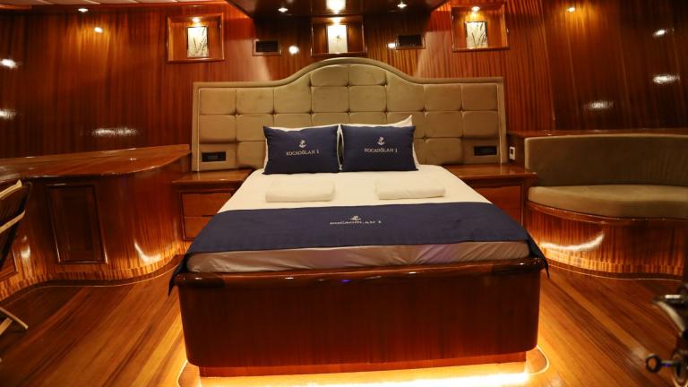 Luxurious cabin with large bed on a yacht.