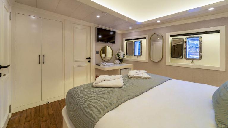 Modern guest cabin with a stylish double bed and amenities on the sailing yacht Queen of Makri.