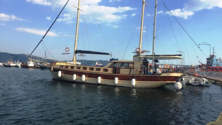 Gulet Aurora with its wooden hull is anchored in the port.