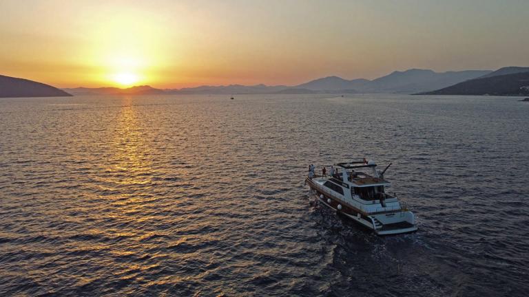 The motor yacht Juliet cruising into the sunset.