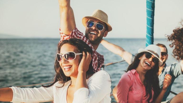 A crowded group of friends is having a pleasant time on the boat they rented together.