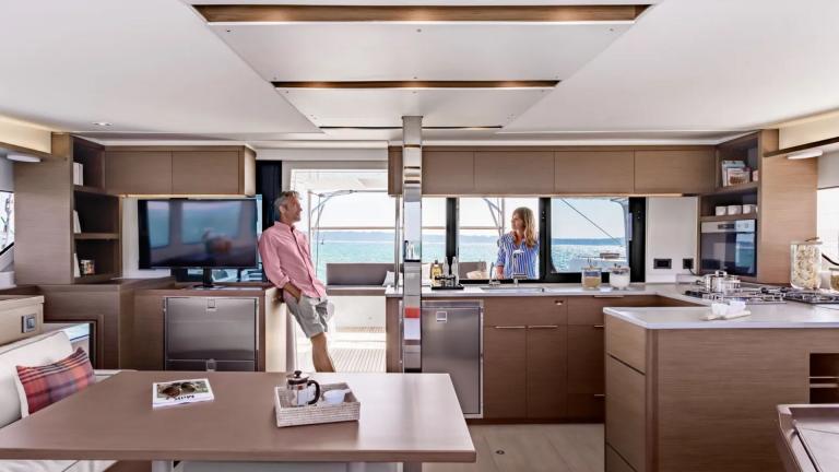 A couple is talking in the spacious lounge of the Catamaran Shanti.