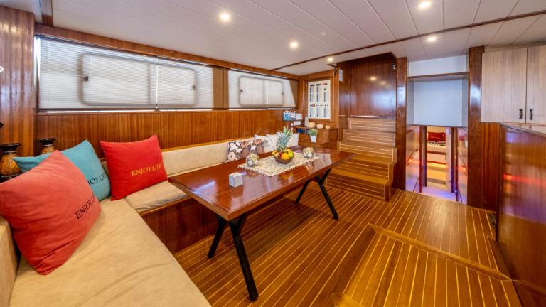 Tastefully furnished saloon area on the Gulet Enjoy Life with comfortable seating and maritime cushions.