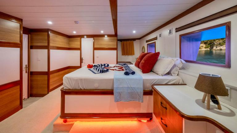 Luxurious cabin with modern amenities and a window view of the sea on the Gulet Enjoy Life.