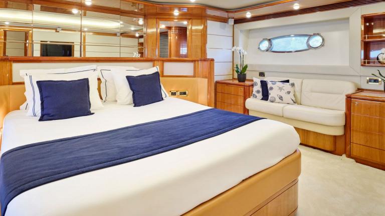 Large bed and elegant decor in the luxurious bedroom of a motor yacht