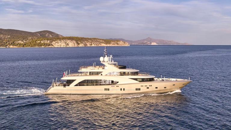 La Pellegrina 1 is anchored in a scenic Athens bay. Luxury motor yacht for summer charter.