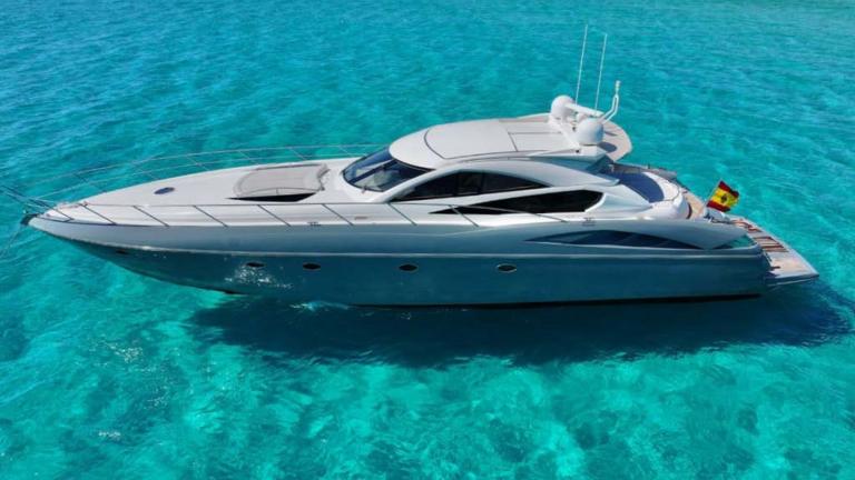 The Talan motor yacht, with its sleek design, is anchored in crystal-clear waters.