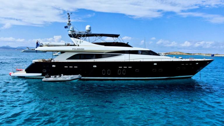 Motor yacht Usoa Bi stands out with its modern design and sleek lines over the turquoise sea.