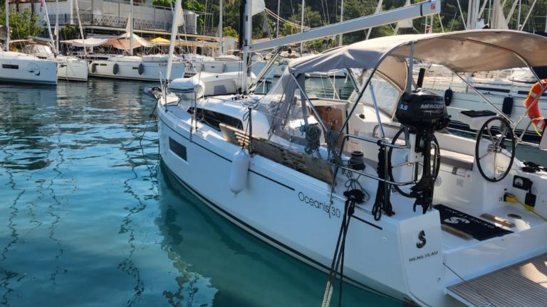 Lima bareboat yelkenli yat limanda, turkuaz sulara karşı demirlemiş şekilde görüntüleniyor.