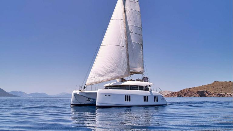 Adara yacht, with its large sail and elegant design, offers a stylish journey in Athens waters.