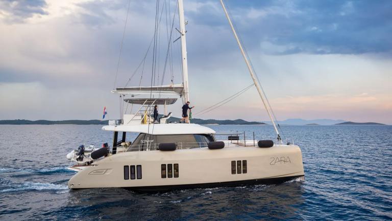 In Kastela the Sunreef 50 Zara sails with a sleek profile across calm blue waters.