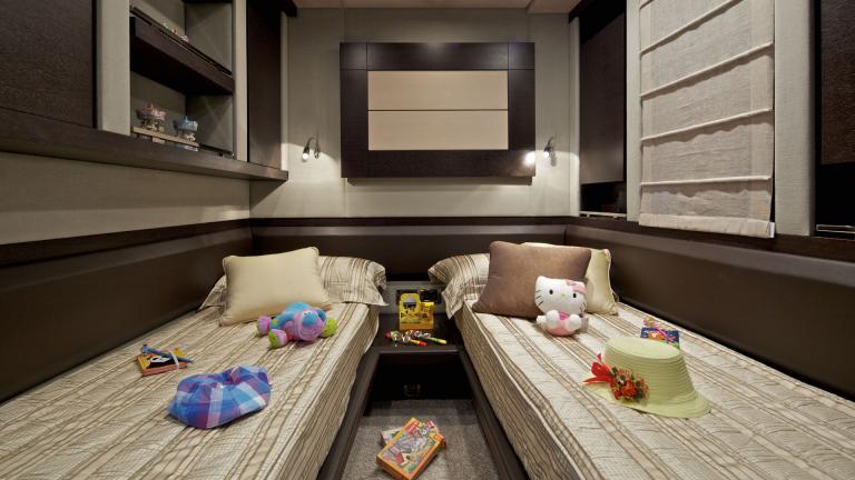 Cozy children's room with two single beds and toys on the motor yacht Thea Malta.