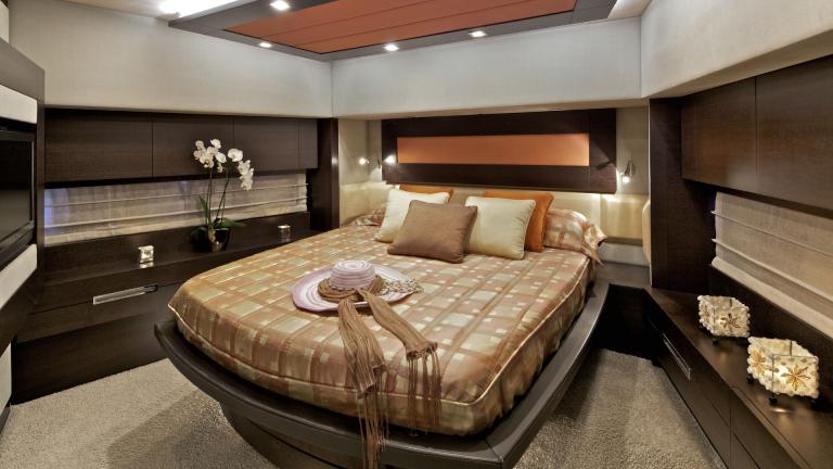 Stylishly furnished guest room with a large bed and elegant details on the motor yacht Thea Malta.