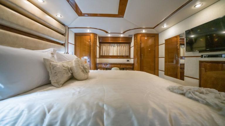 Comfortable king size bed in luxury bedroom with en-suite bathroom, sideboard , wardrobes and TV.