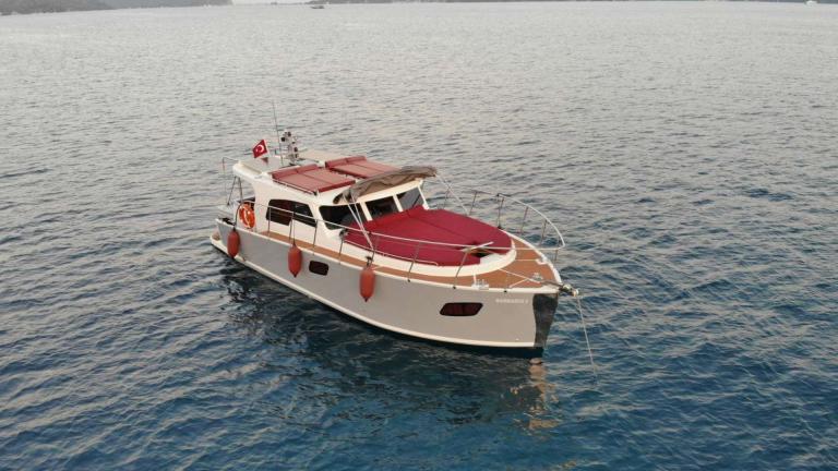Barbaros 3 lobster yacht rests calmly at anchor in a quiet bay near Marmaris.