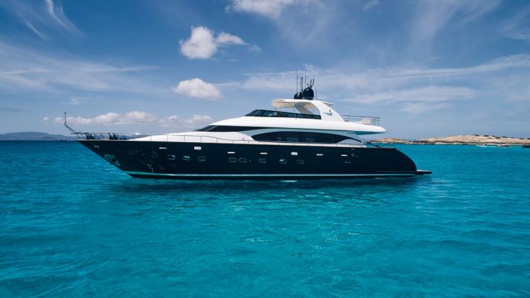 Lady KC anchored in turquoise waters offers a luxurious and elegant journey.