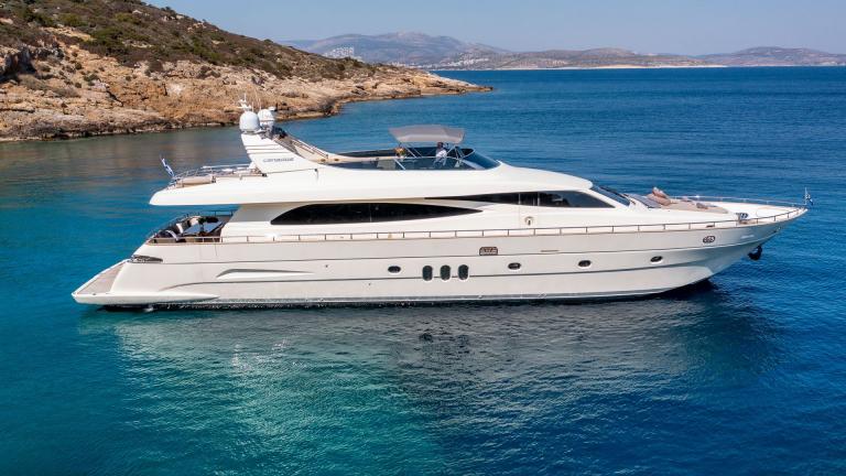 The luxury motor yacht Miraval anchored in turquoise waters, showcasing its elegant and spacious design.