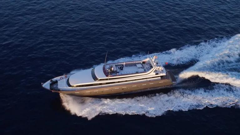 Paula 3 motor yacht cruises swiftly through the sea, leaving a trail of white waves behind.