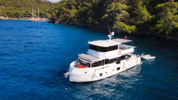 Trawler yacht Nayk 1 anchored in a calm bay, offering a tranquil environment.