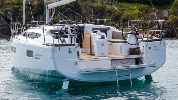 Sky Asya yacht's aft deck with dual steering wheels and a spacious seating area, anchored at sea.