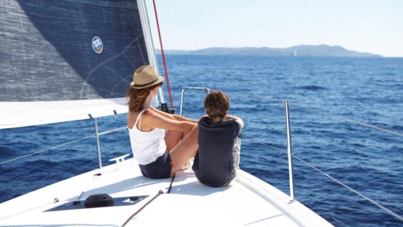 Mother and child sitting on the foredeck of Sky Asya yacht, gazing at the sea.