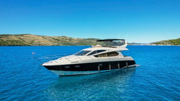 The yacht 2 Drunk is anchored calmly in the open sea, showing its serene position.