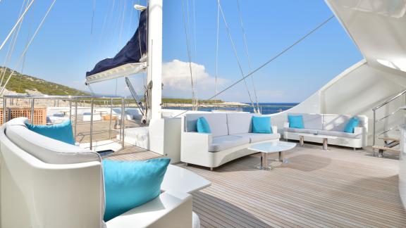 Spacious sun deck of the Meira sailing yacht with comfortable seating and sea views.