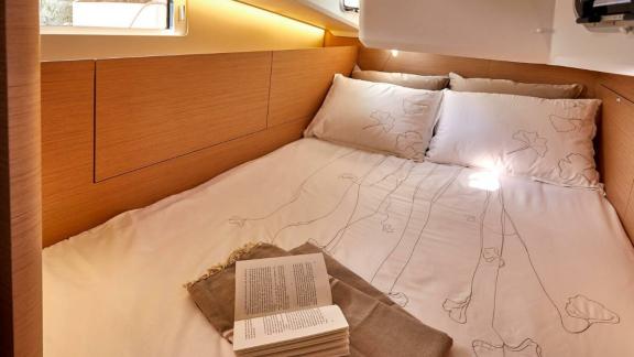 Sky Asya yacht's double cabin with wooden details and cozy pillows.