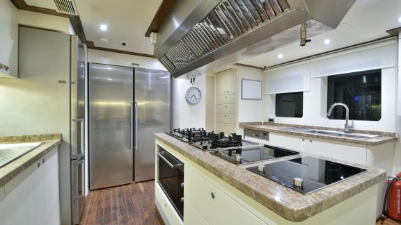 Fully equipped, modern kitchen of the Meira sailing yacht with high-end appliances.