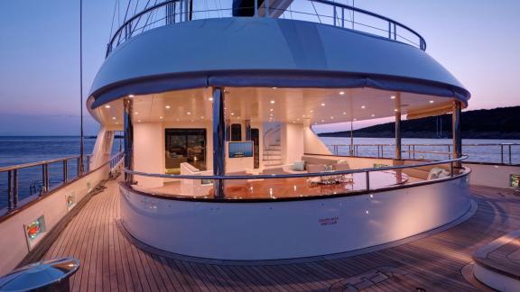 The Meira sailing yacht at sunset with illuminated outdoor area and relaxing atmosphere.