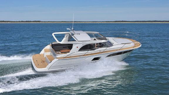 The motor yacht 7 Happy days is seen cruising fast on the open sea. It stands out with its sleek and modern design.