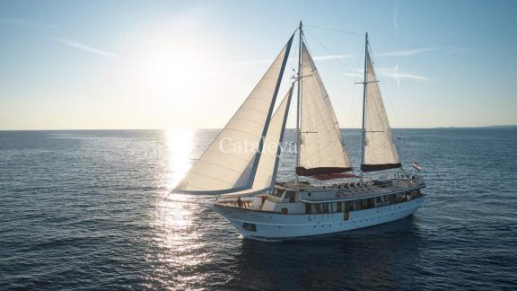 Gulet Cataleya with 9 cabins sails at sunset in the waters of Croatia.