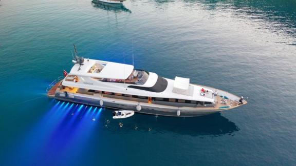 The people on the deck of the luxury yacht, enjoying the blue voyage.